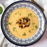 Healthy potato soup in a bowl topped with herbs and spices.