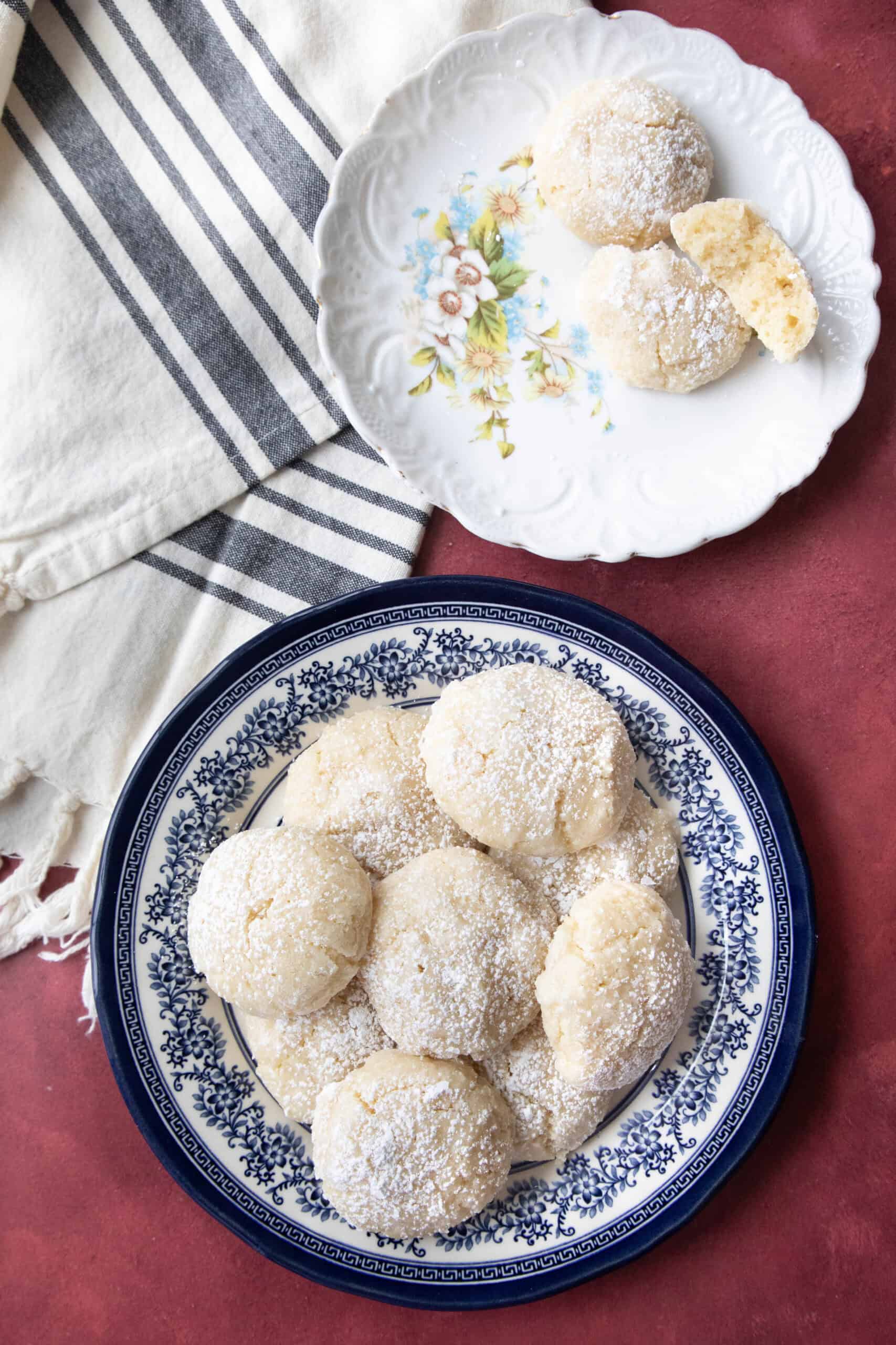 Best Amaretti Cookies Recipe Amaretti cookies served in a plain white dish and a decorative navy blue and white dish