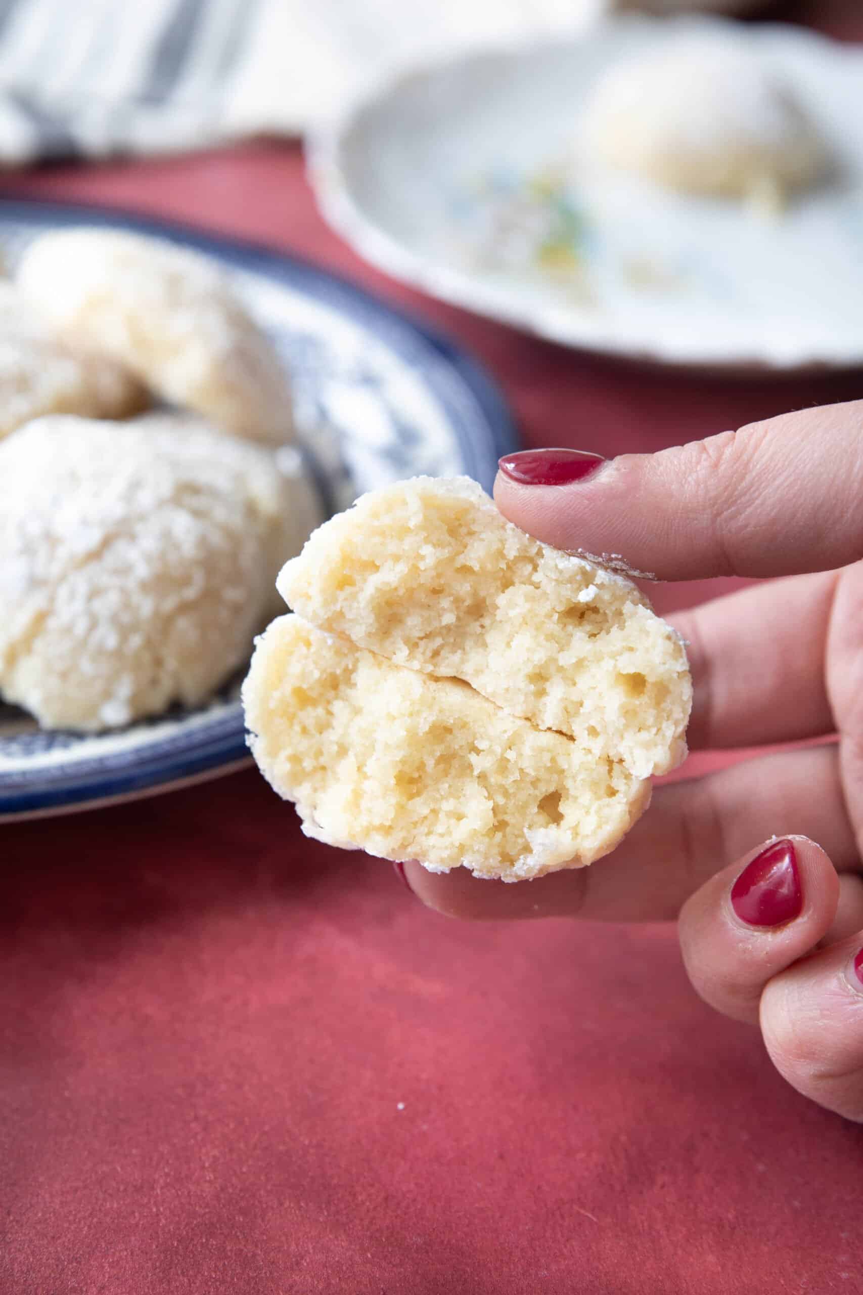 Best Amaretti Cookies amaretti cookies served in two separate plates with one held closer to see the soft chewy inside