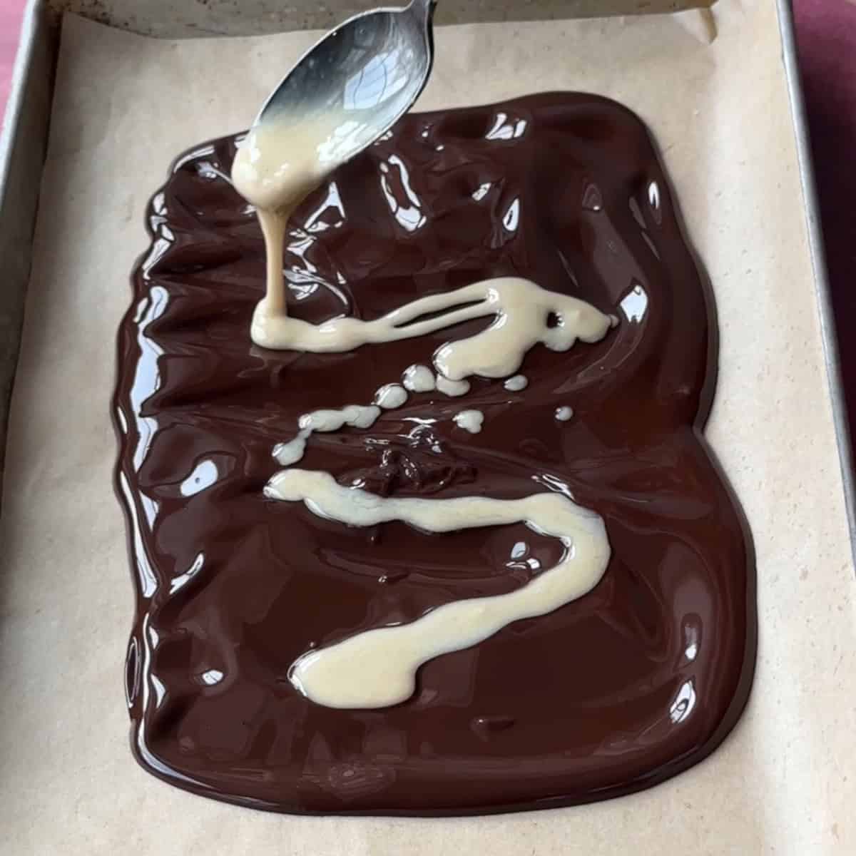 Adding tahini to melted dark chocolate.