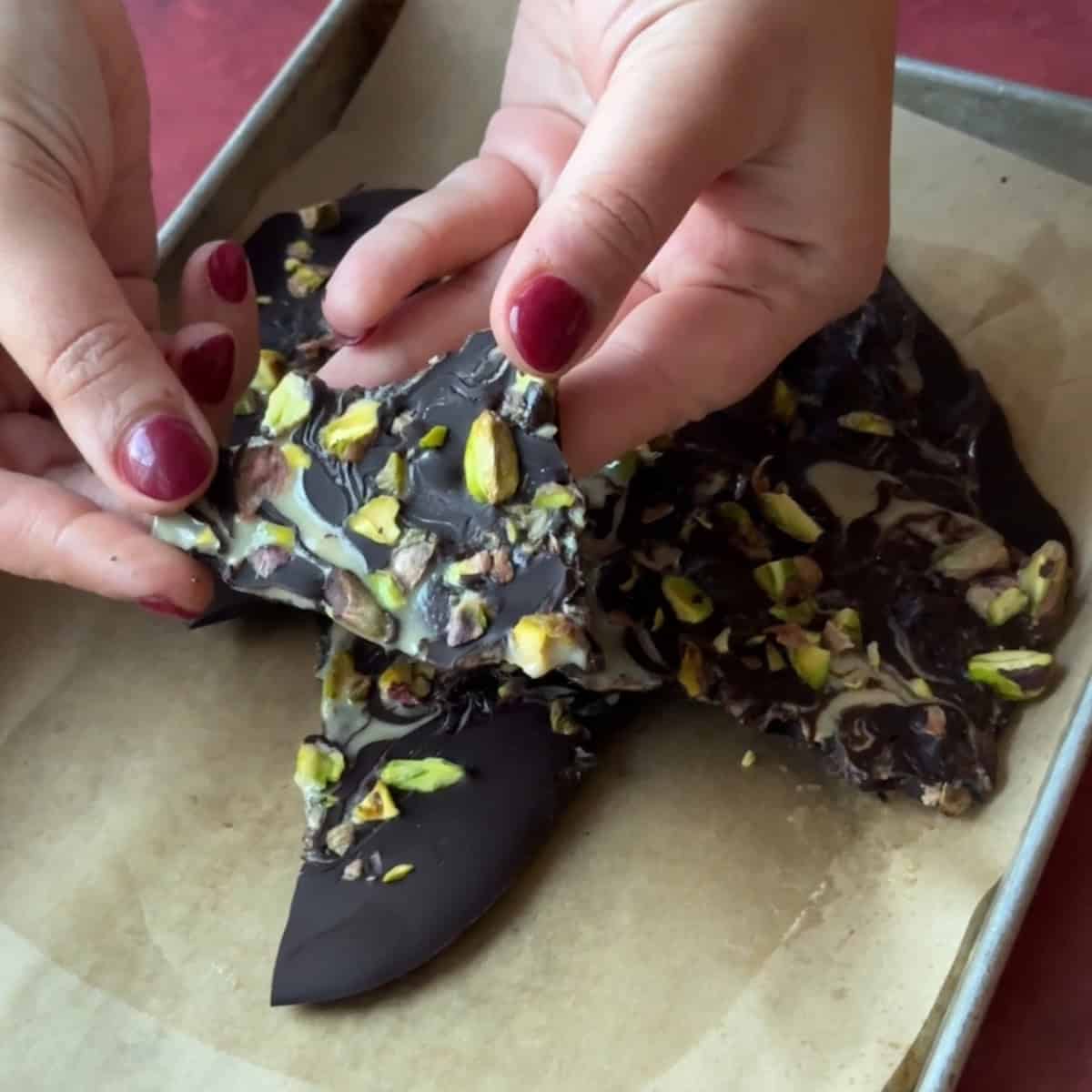 Pieces of chocolate bark with pistachios and tahini.