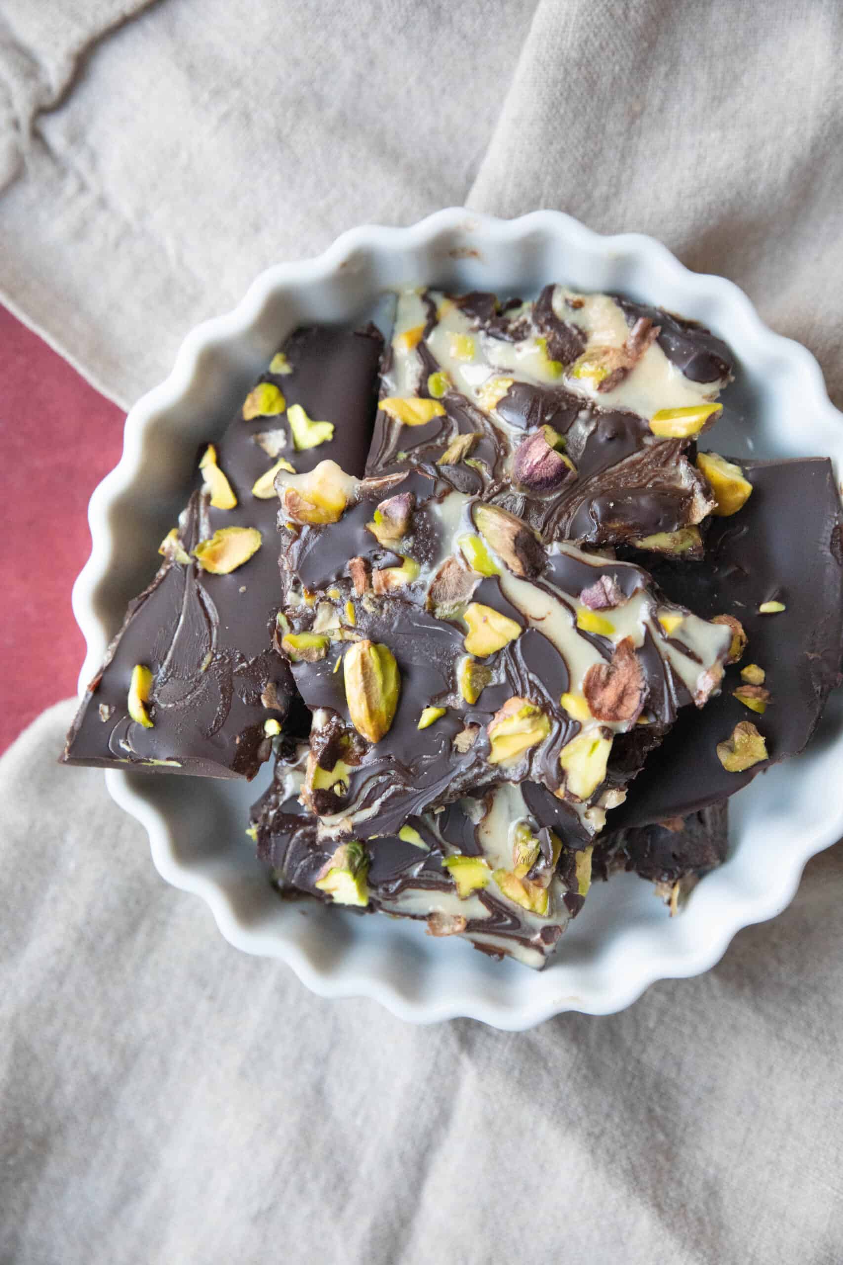 Tahini and Chopped Pistachios Chocolate Bark Tahini chocolate bark pieces in a bowl.