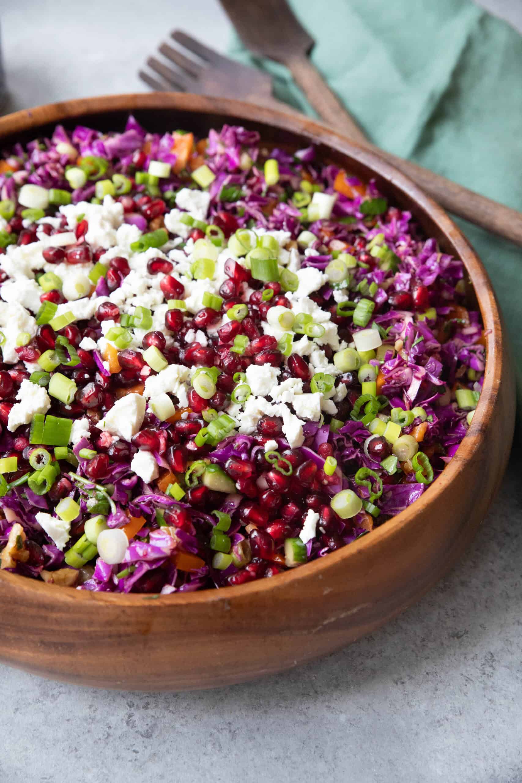 Best Pomegranate Salad Recipe red cabbage pomegranate salad served in a wooden bowl