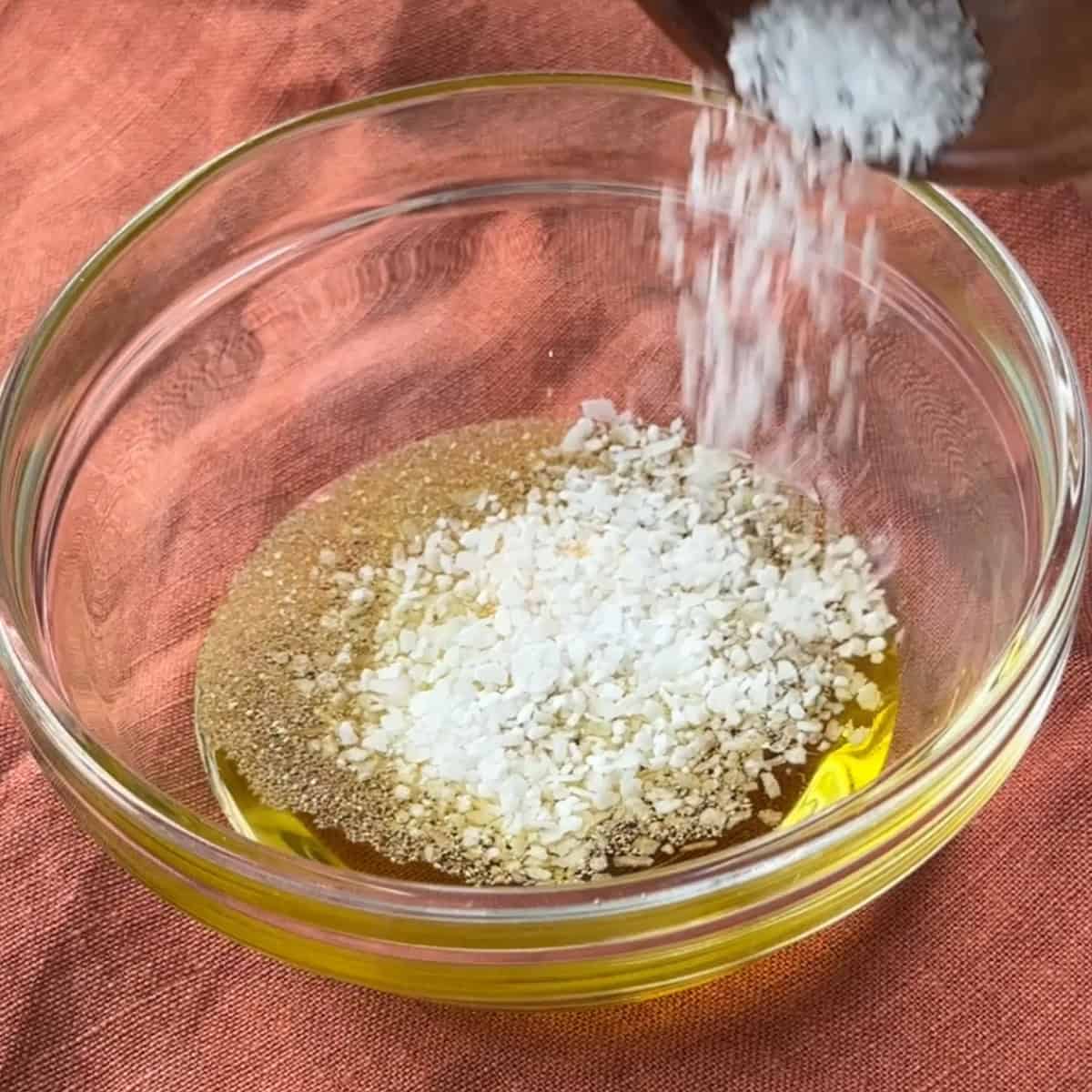add oil, salt, and garlic powder to bowl