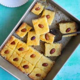 pieces of basbousa on a baking pan.