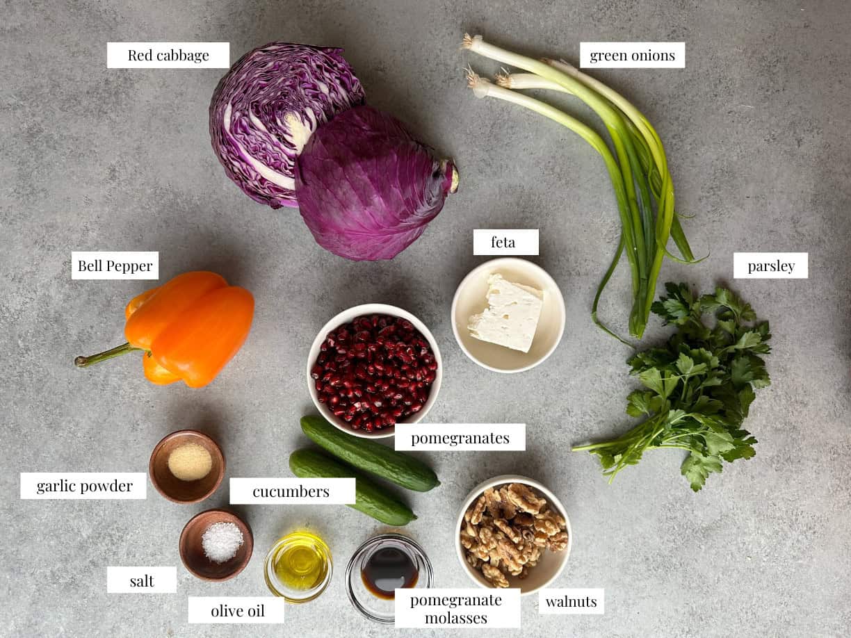 Pomegranate Salad Ingredients red cabbage pomegranate salad ingredients including pomegranate arils, red cabbage, bell pepper, feta cheese, parsley, lemon juice, and cucumbers