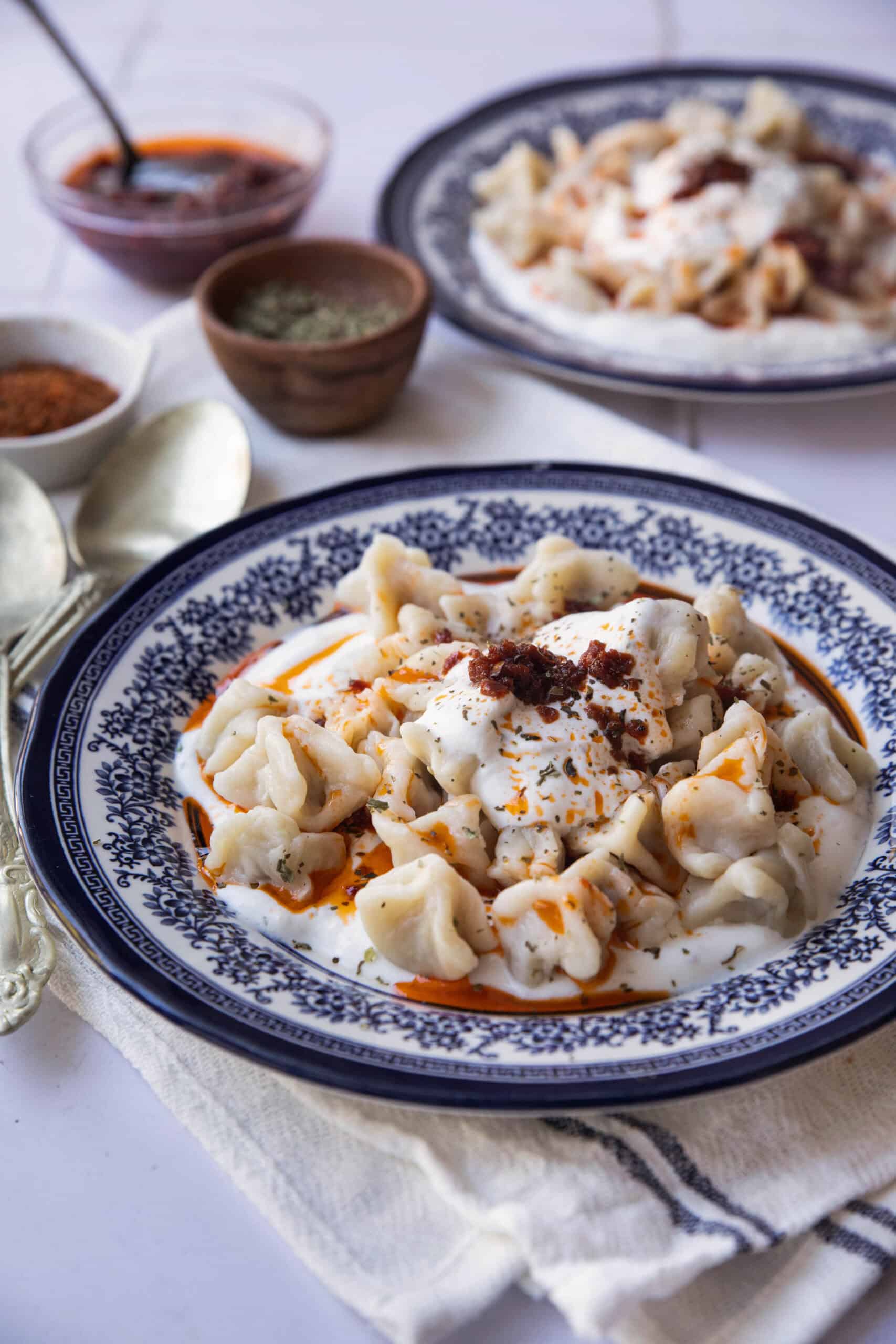 Best Manti Recipe two dishes of manti dumplings served with the butter tomato sauce