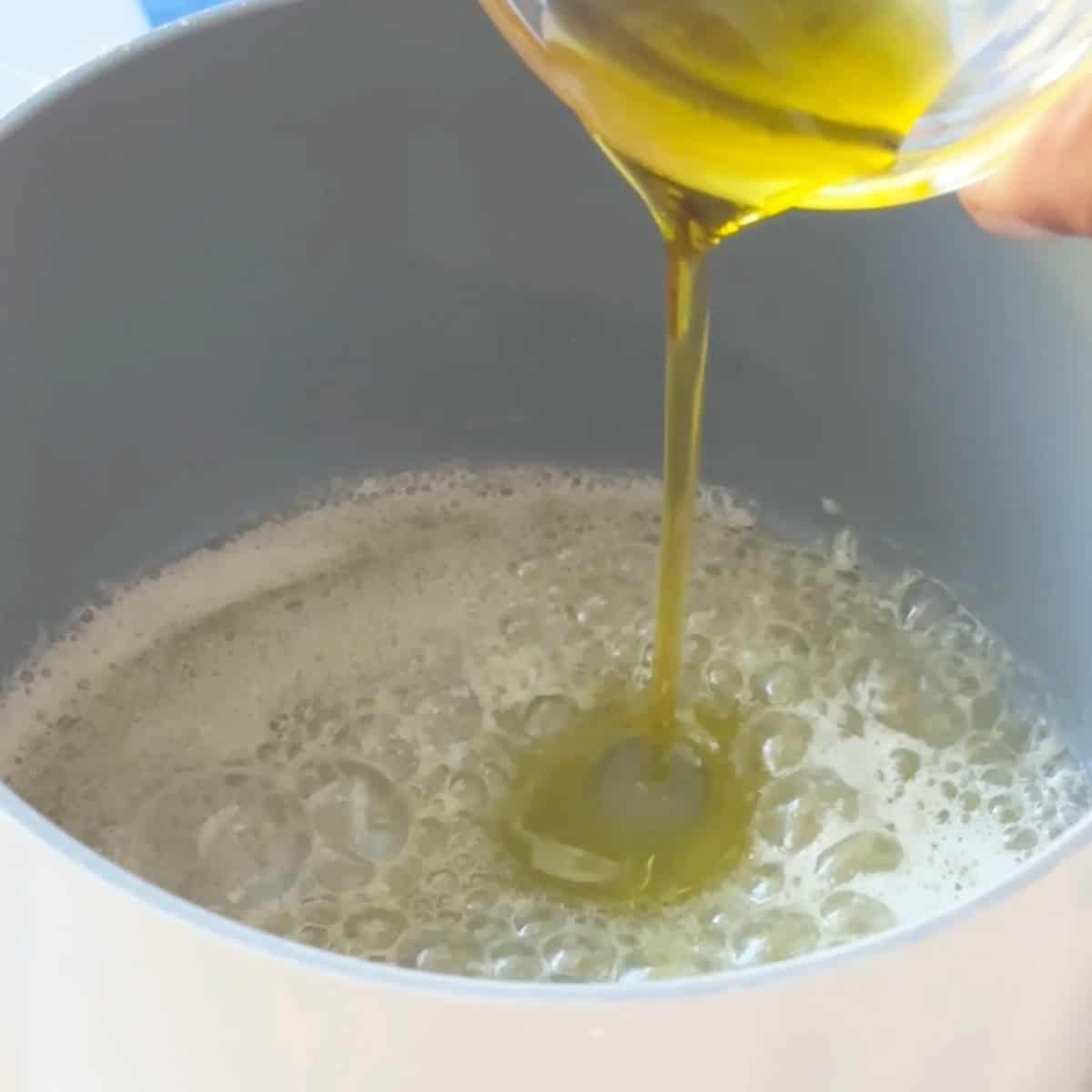 Tomato Sauce for Manti Drizzling olive oil over the melted butter in the pan