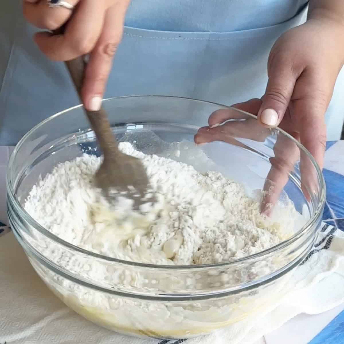 How to Make Manti Dough mixing the manti dough mixture with a spatula