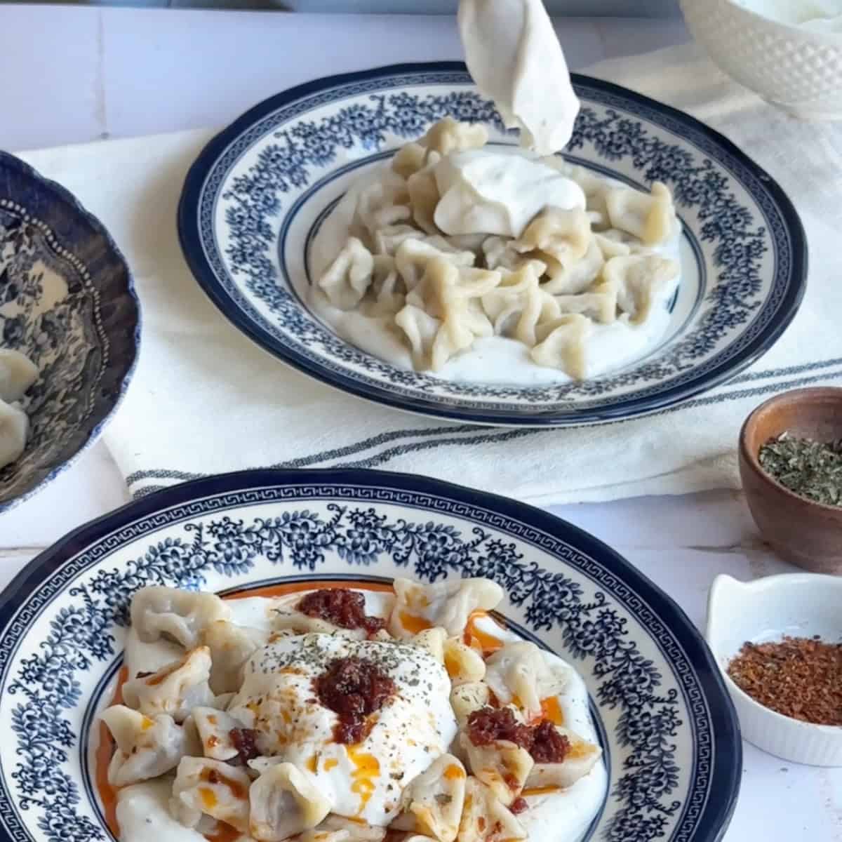 Additional yogurt dolloped on top of the manti for extra creaminess