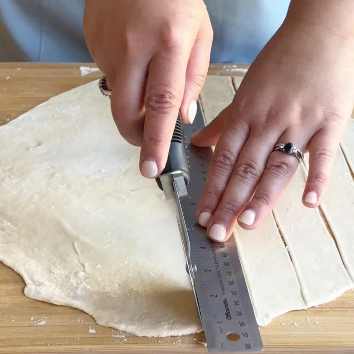 Cutting Manti Dough Cutting the dough with a cookie cutter into even parts