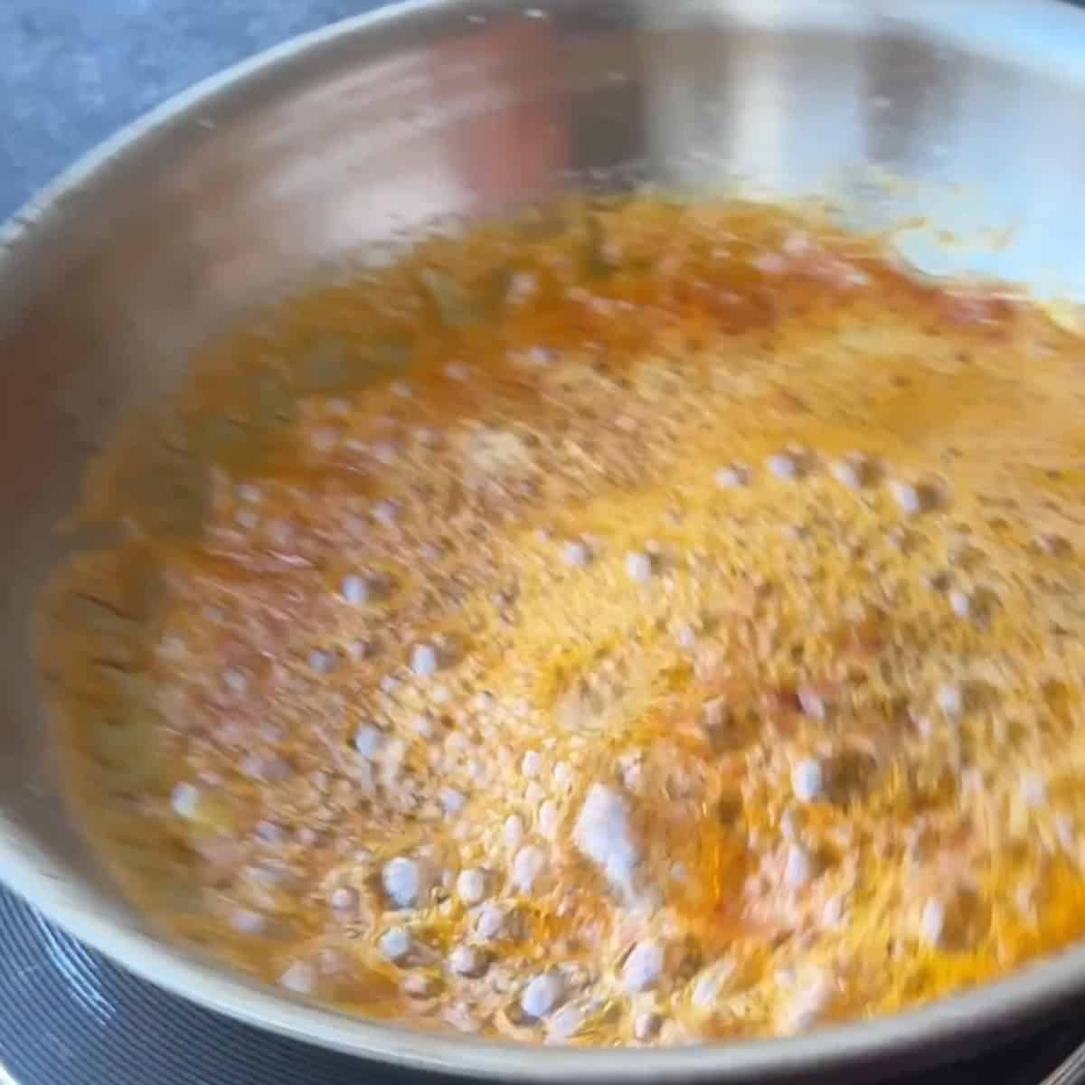 • The spiced butter bubbling slightly as the flavors infuse together.