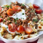 A plate of Turkish pasta topped with yogurt.