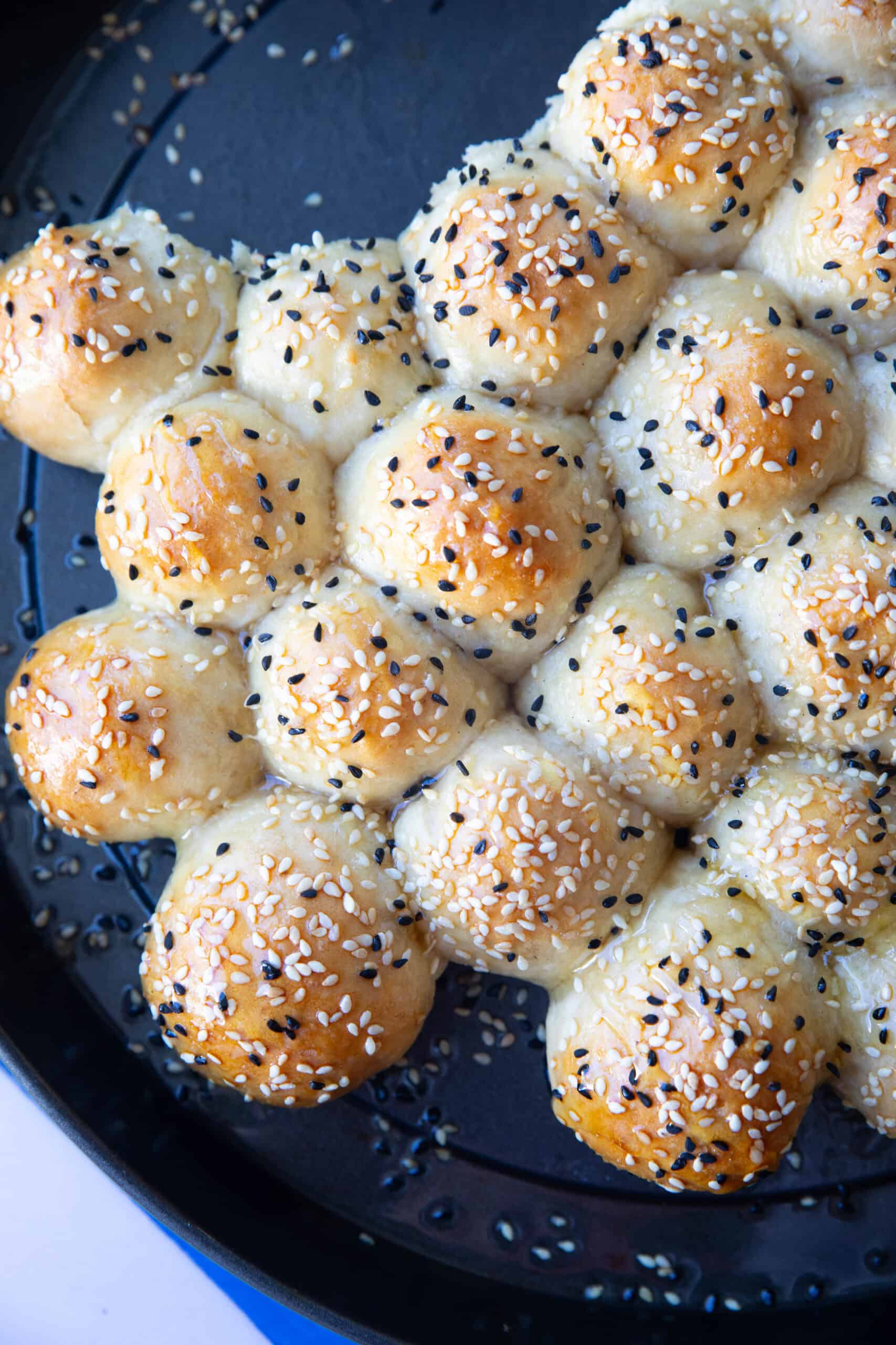 Honeycomb bread fresh out of the oven, with perfectly risen dough balls, a shiny honey glaze, and an inviting, warm appearance.