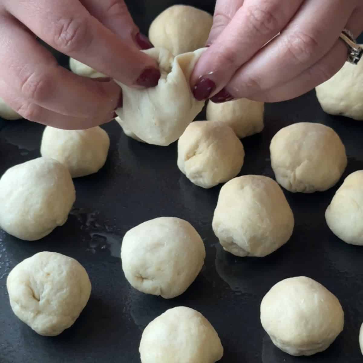 closing the dough after filling it with cream cheese
