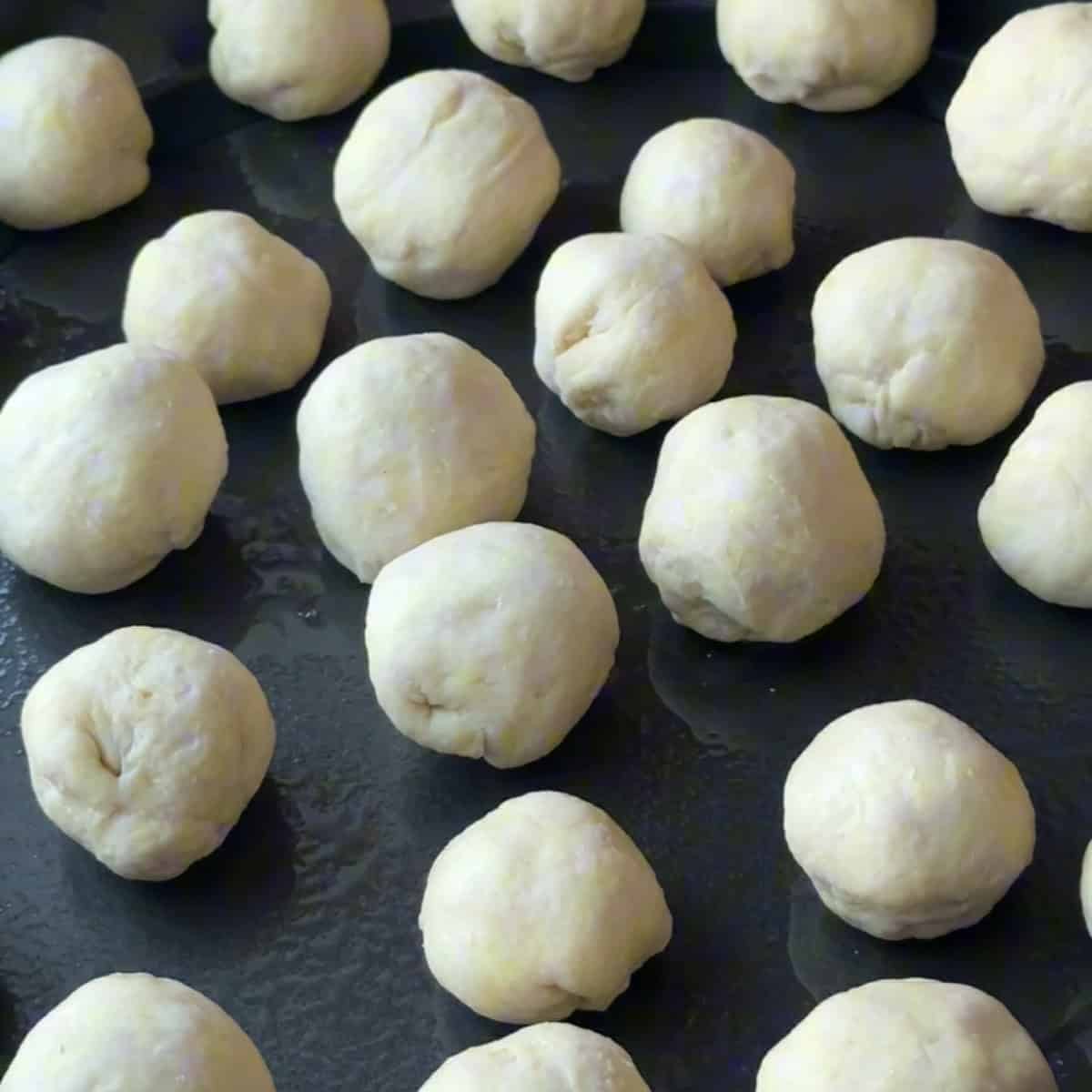 placing the dough balls on a tray