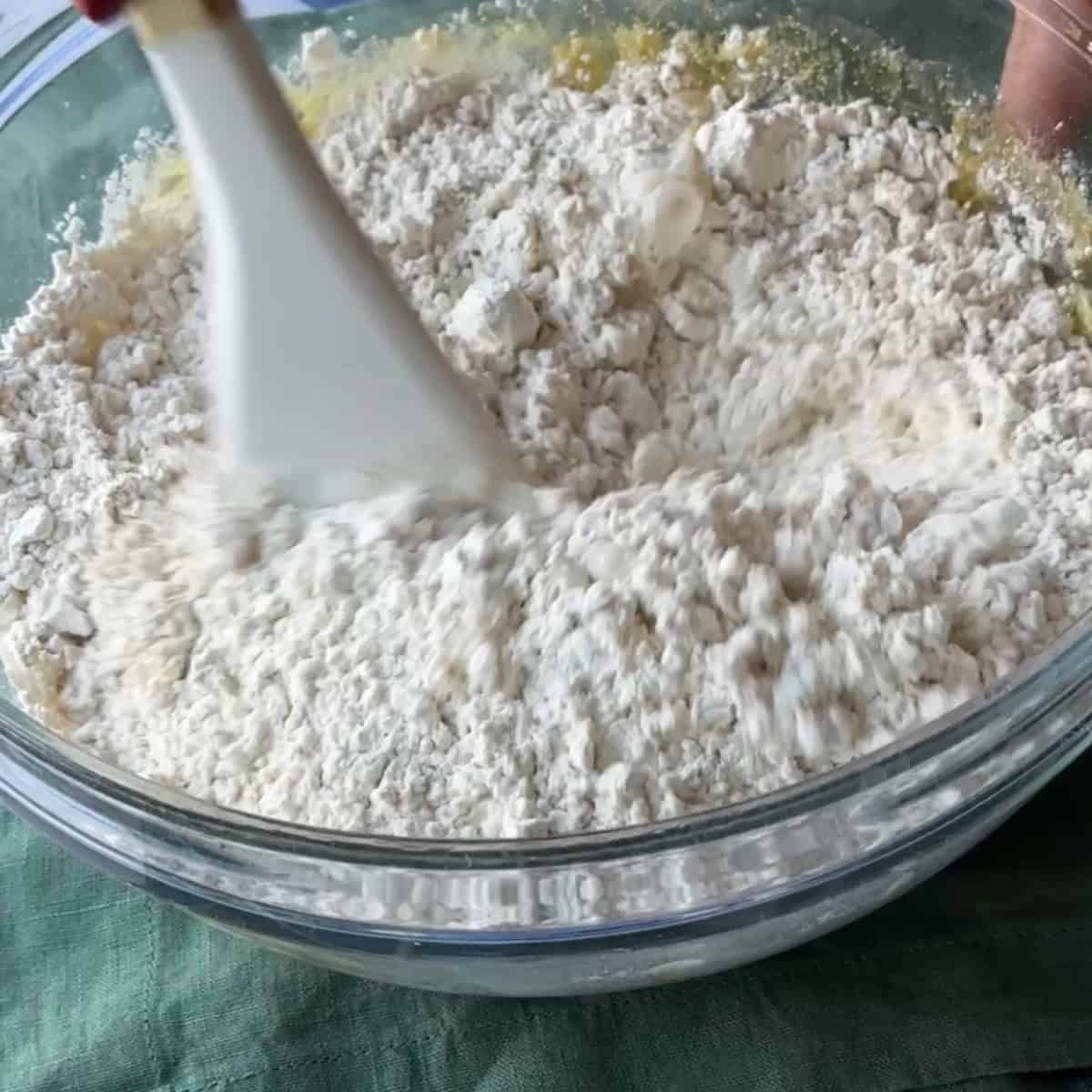 mixing the wet and dry ingredients in the glass bowl to make the dough