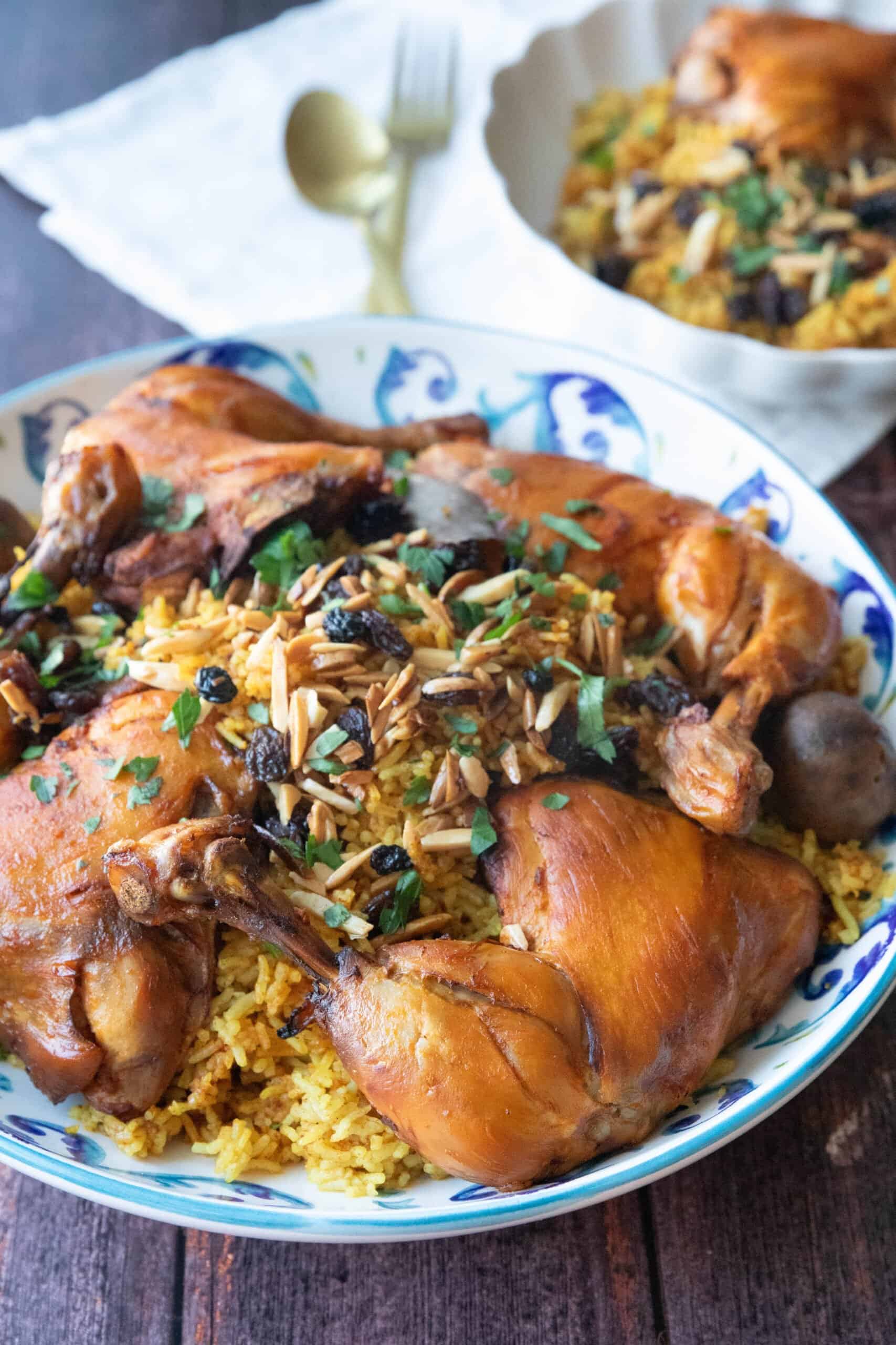 Machboos Chicken and Rice machboos with garnish served in a decorative bowl