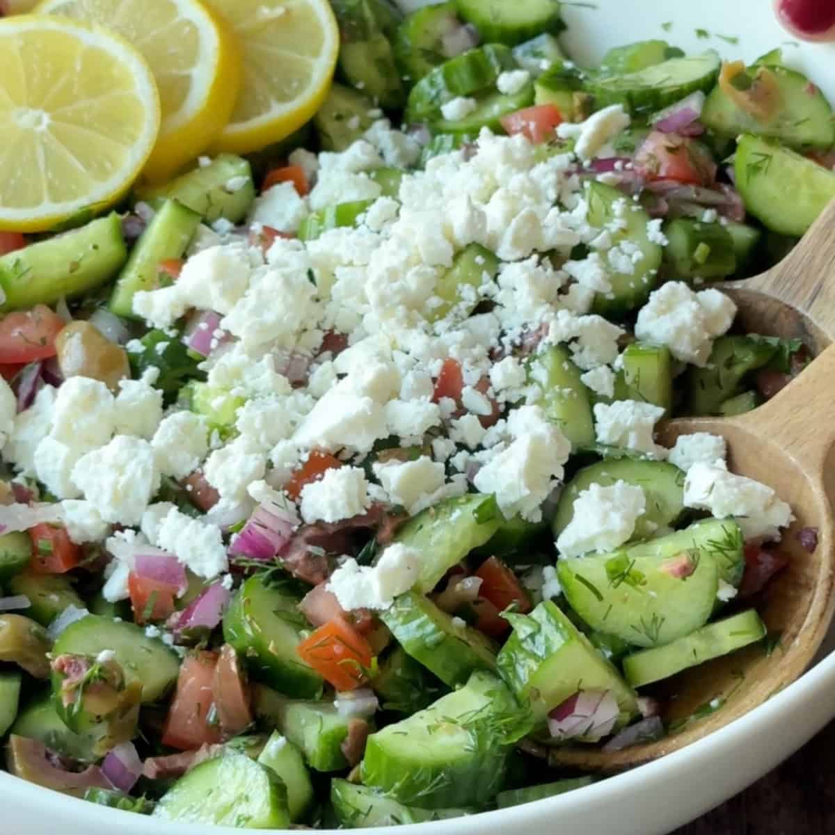 How to Make Mediterranean Cucumber Salad a close up view of Mediterranean cucumber salad topped with crumbled feta