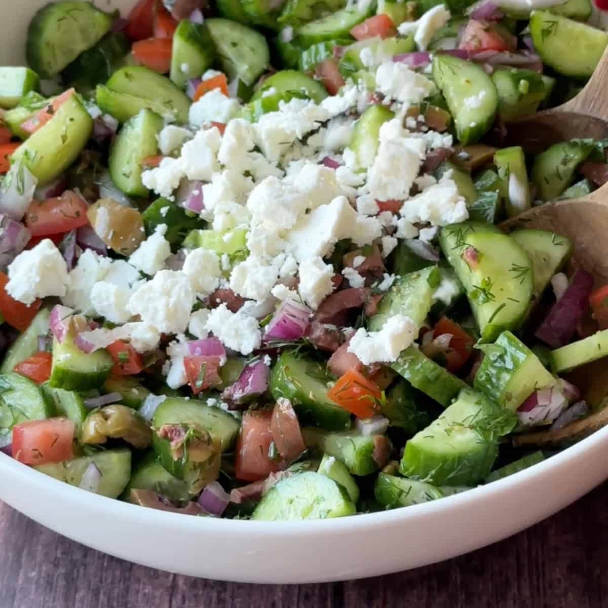 How to Make Mediterranean Cucumber Salad a close up view of Mediterranean cucumber salad topped with crumbled feta
