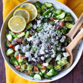 a close up view of Mediterranean cucumber salad topped with crumbled feta