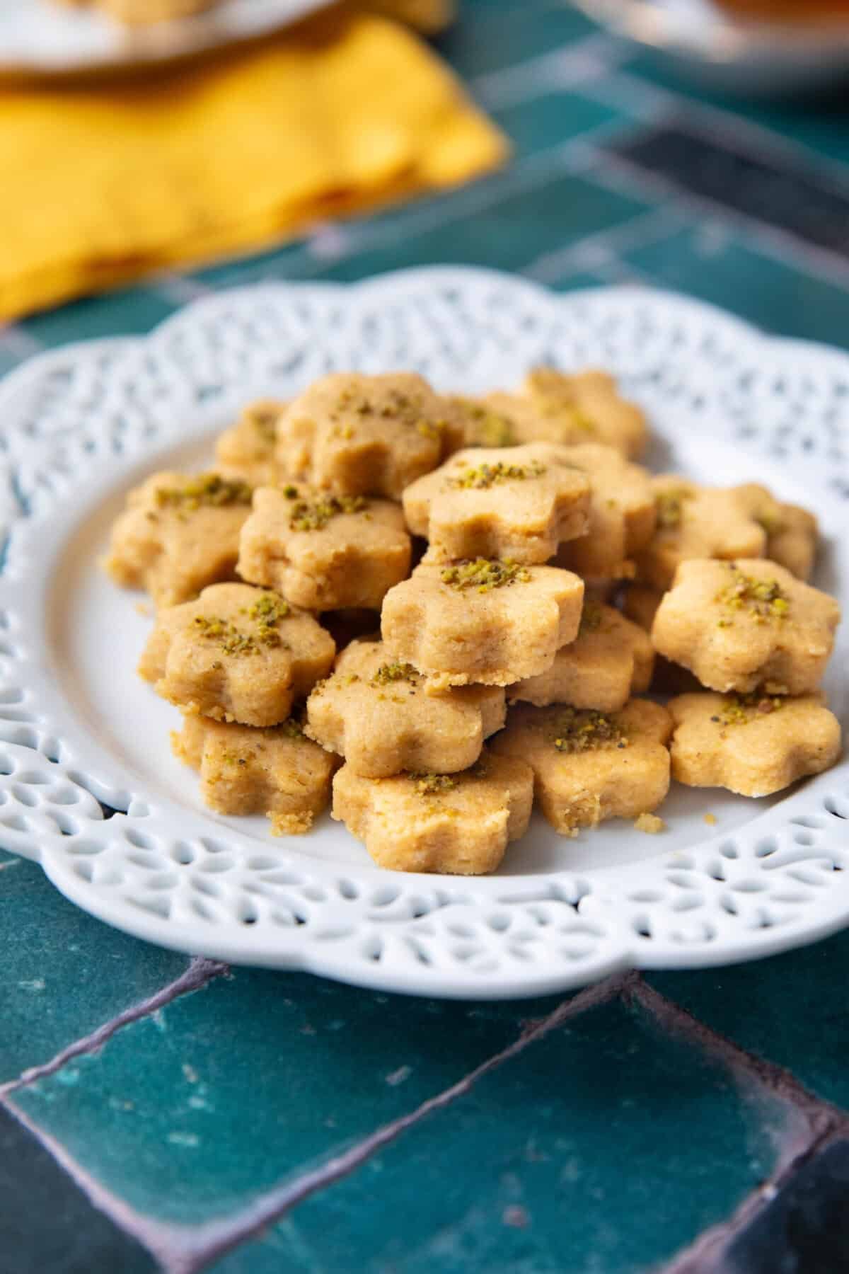 Gluten-free Persian chickpea cookies beautifully displayed on a white plate, perfect for Nowruz celebrations.