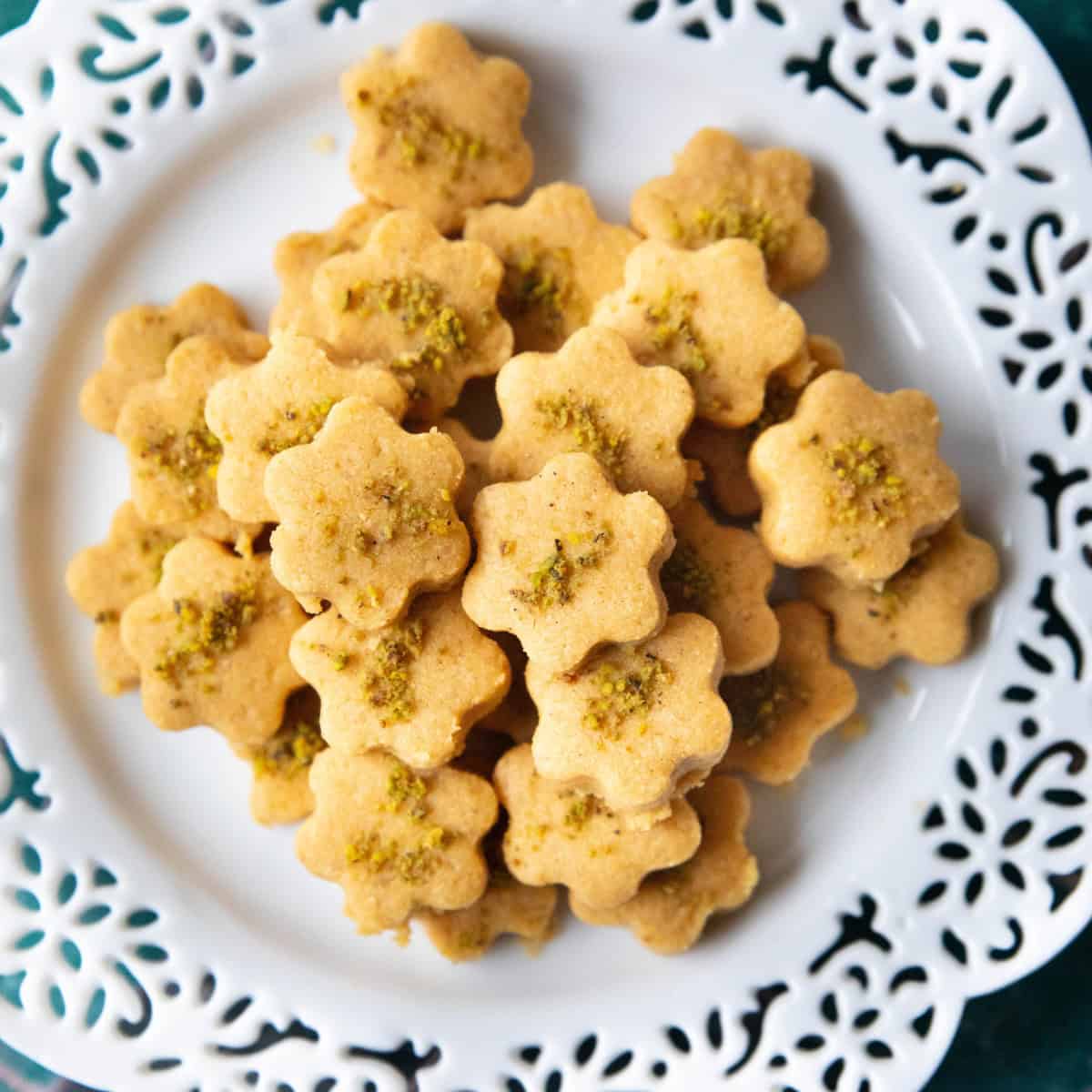 Naan Nokhodchi Recipe A batch of homemade Persian chickpea cookies resting on a white plate, ready to be enjoyed with tea.