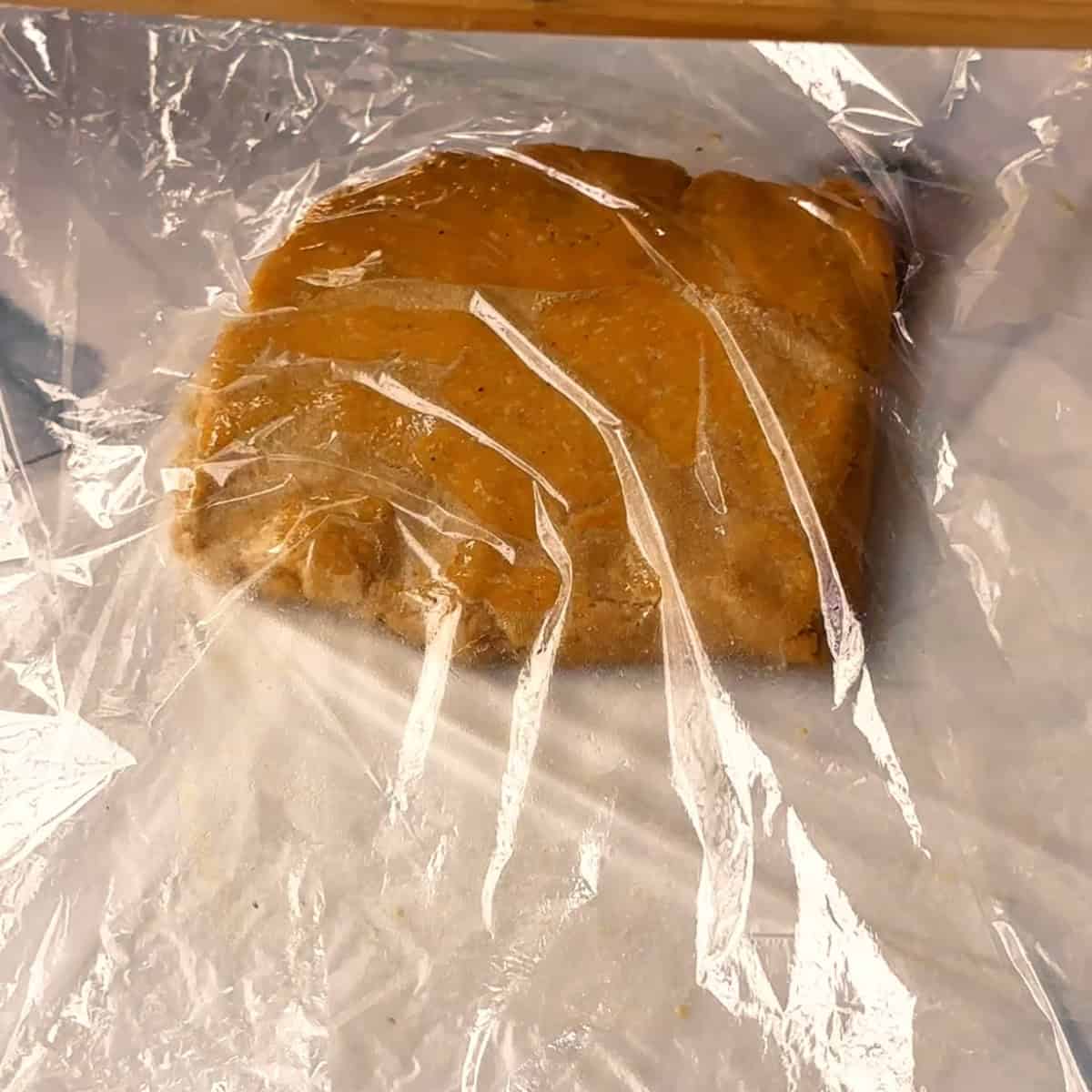 Persian Cookies placing nokhodchi dough between two pieces of plastic wrap
