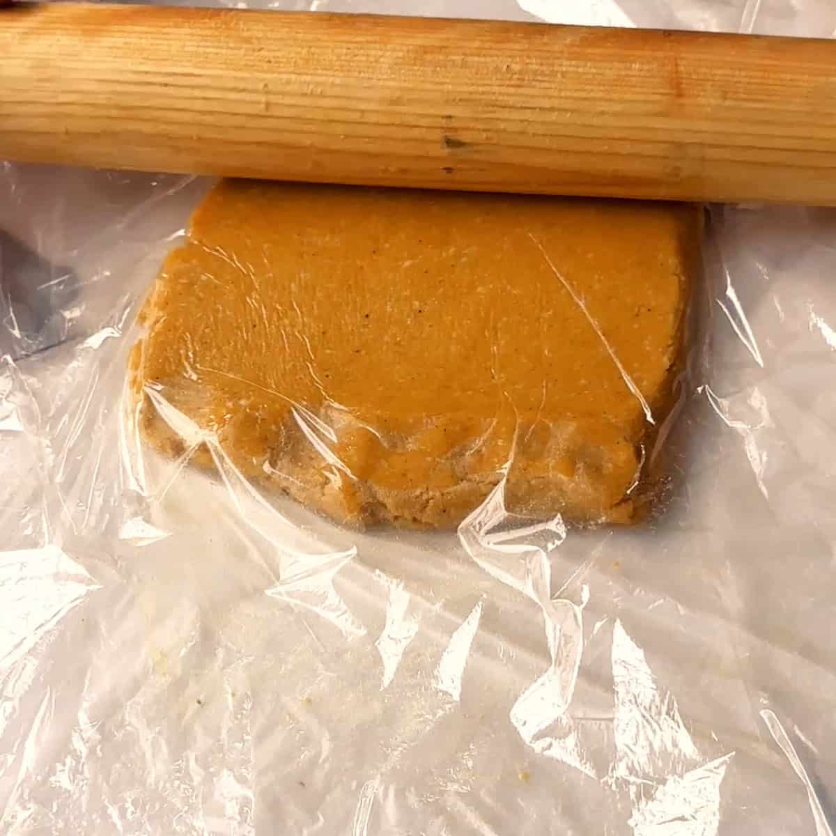 rolling the dough betwee two pieces of plastic wrap