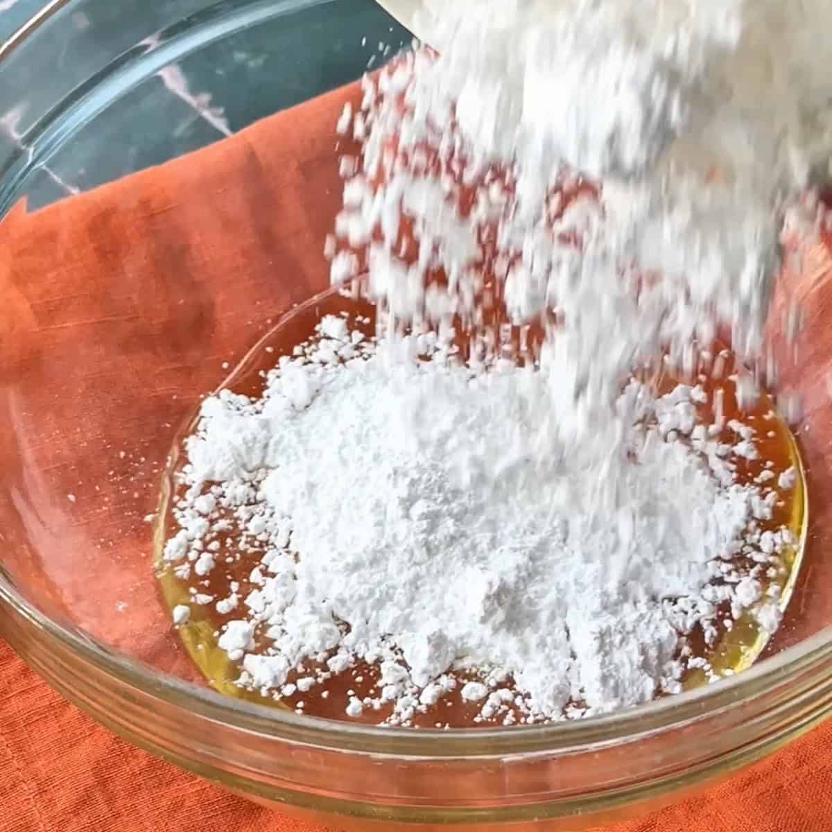 adding powdered sugar to the canola oil