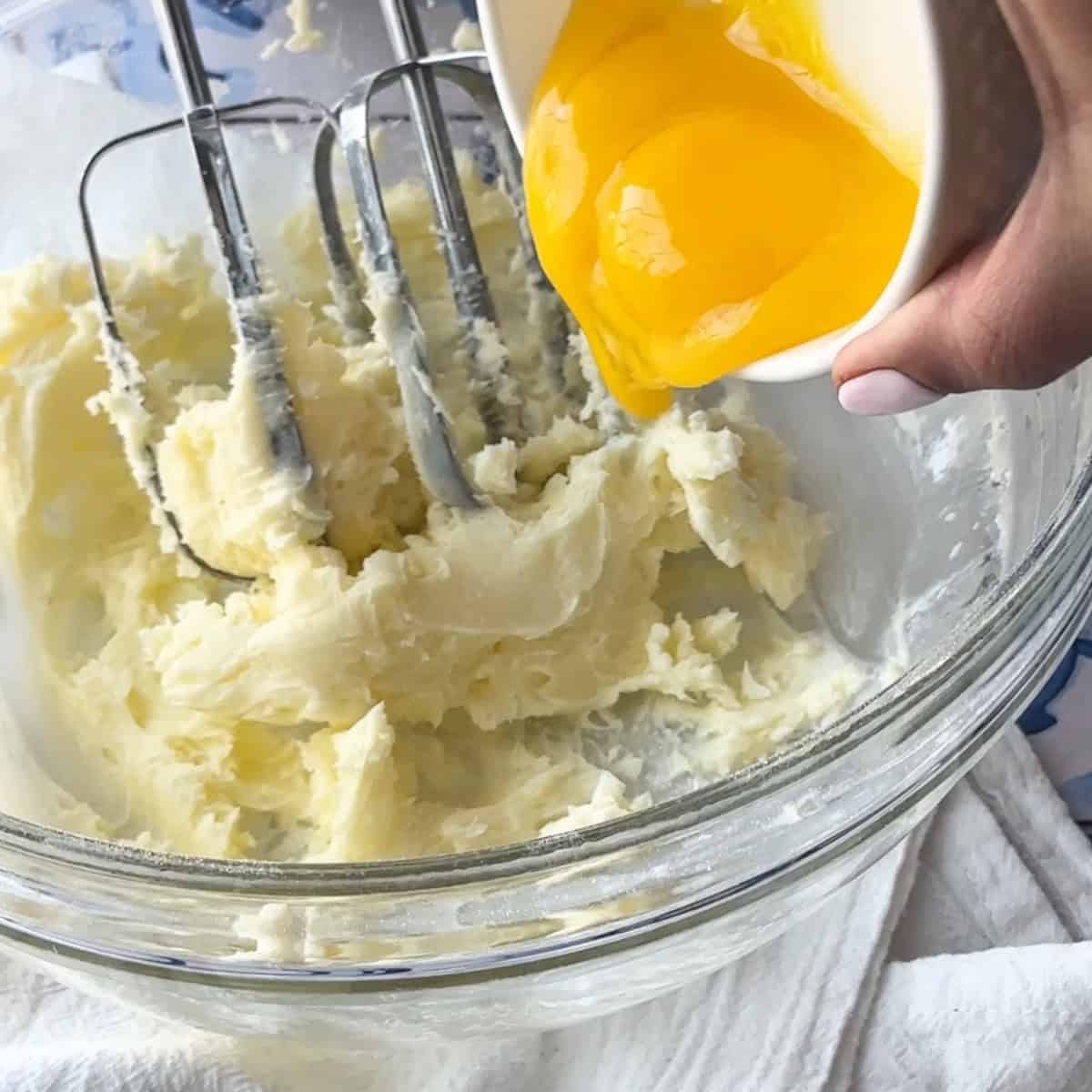 adding egg yolks to the butter mixture