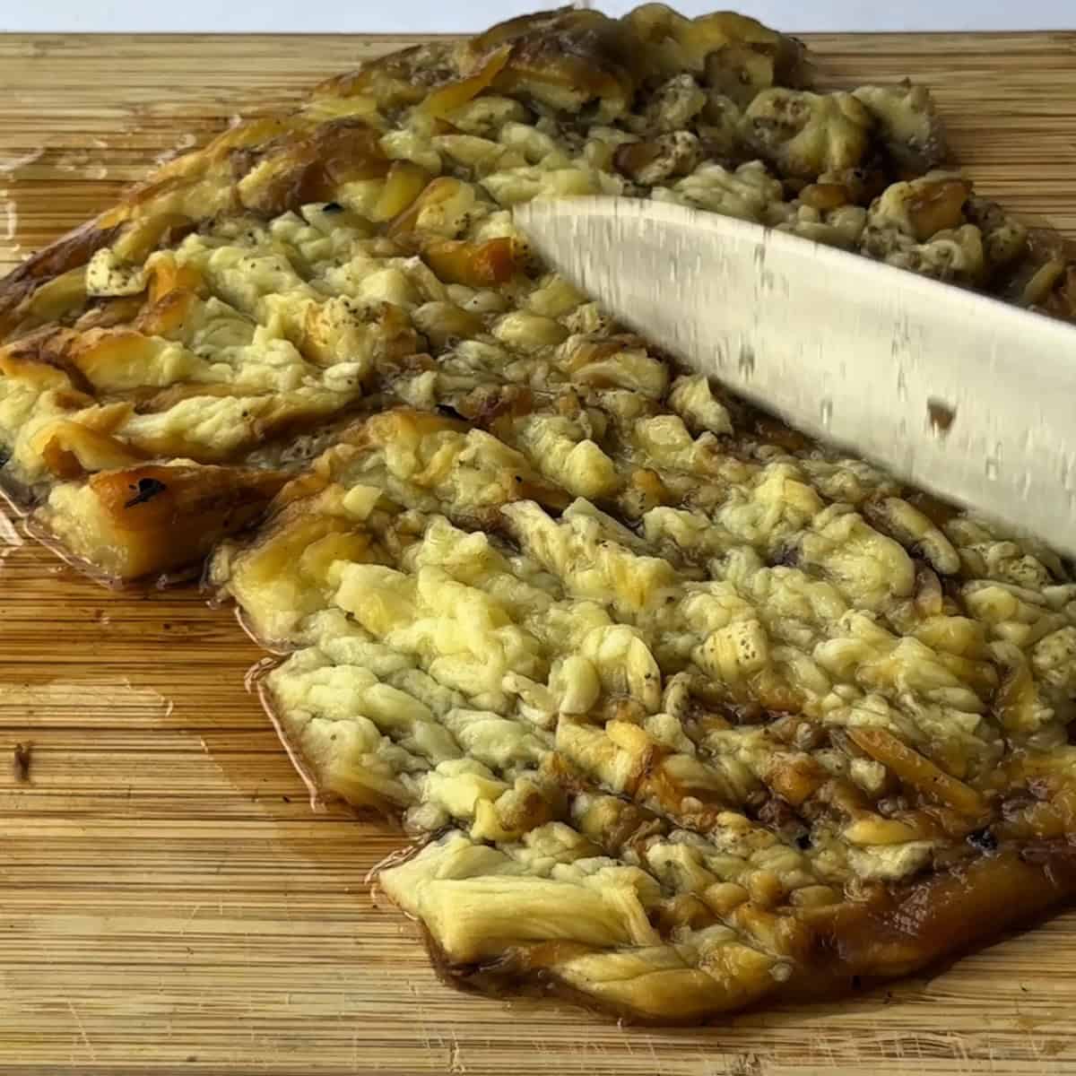 Mashing the eggplant with a knife
