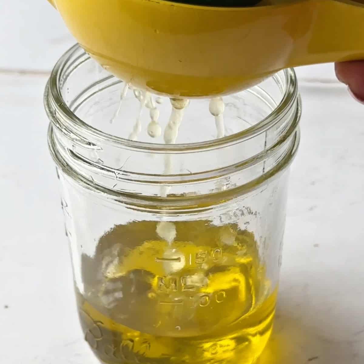 squeeze the fresh lemon over the olive oil in the mason jar