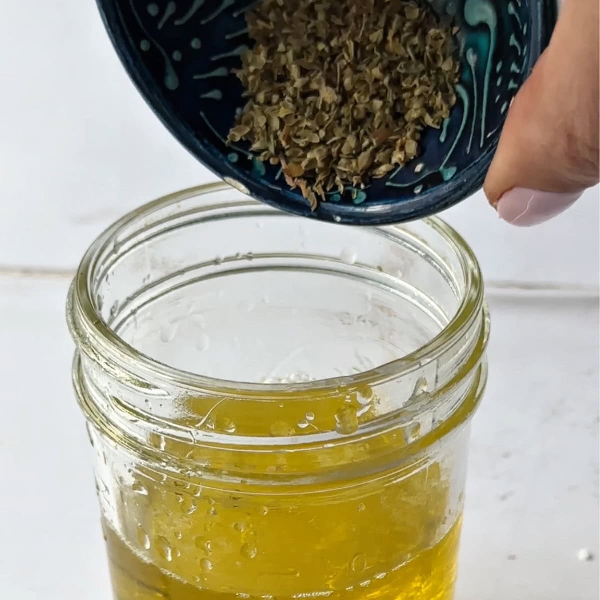 add dried oregano to the olive oil and freshly squeezed lemon juice