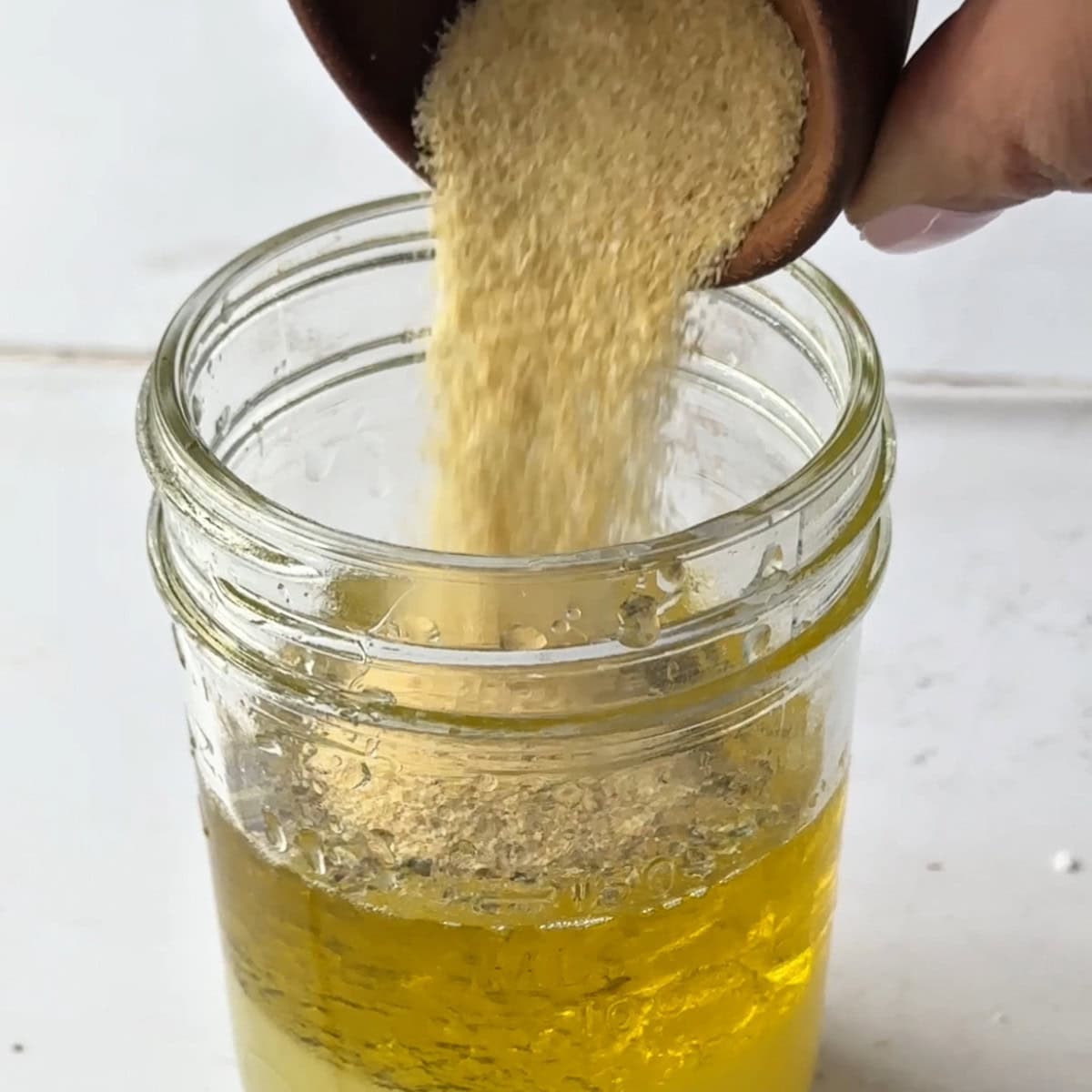 add garlic powder and onion powder to the olive oil, freshly squeezed lemon juice, and dried oregano