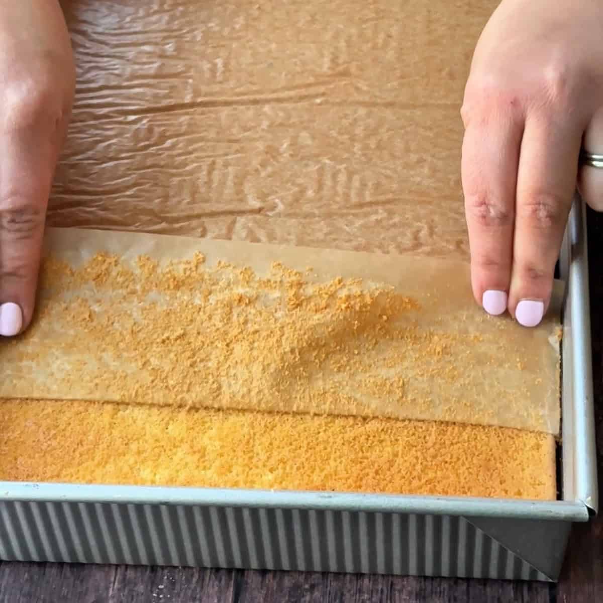 removing the parchment paper from the bottom of the cake