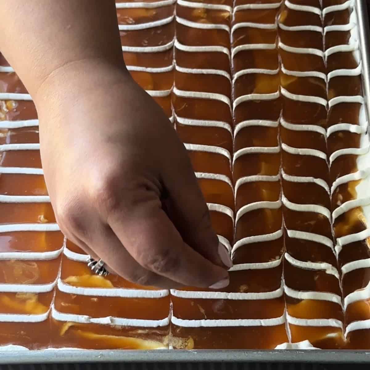 Using a toothpick to drag through the lines in an opposite direction, creating beautiful swirls.