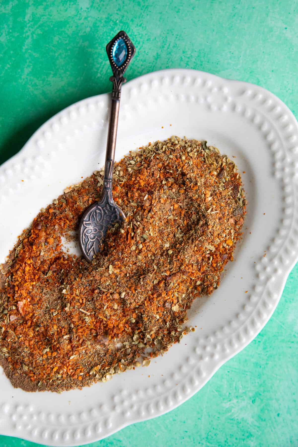 Turkish Spice Blend a top shot of Turkish spice mix in a platter with a metal teaspoon