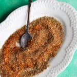 a top shot of Turkish spice blend in a platter with a metal teaspoon