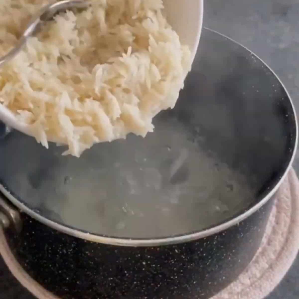 Add the rice to the boiling water.