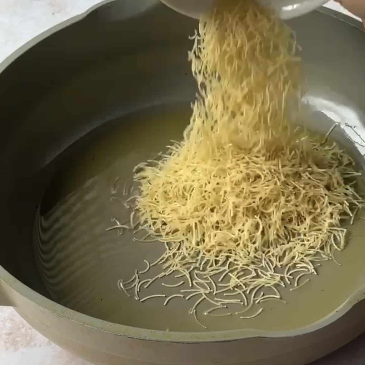 Vermicelli added to melted ghee. 
