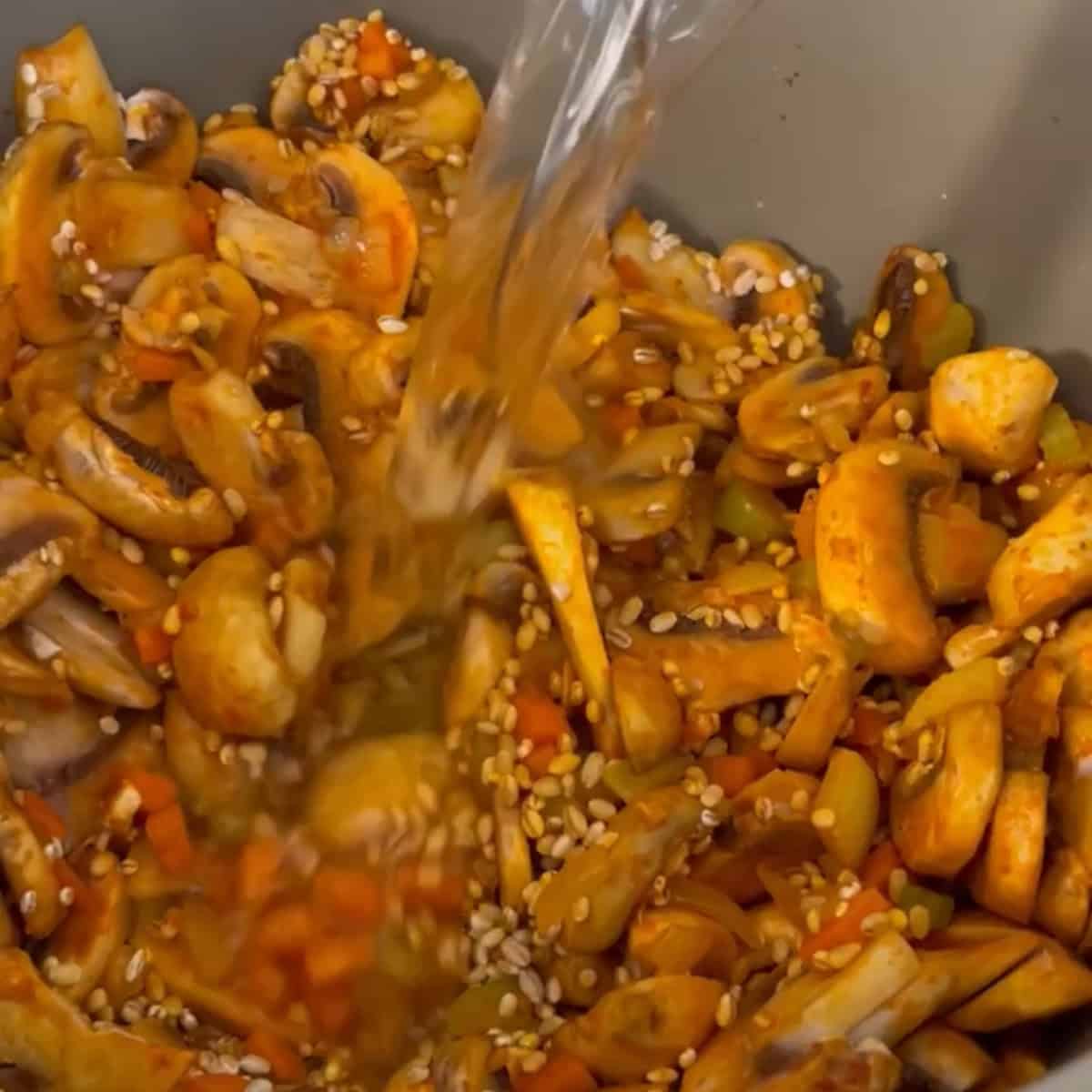 Add water to the barley and vegetables