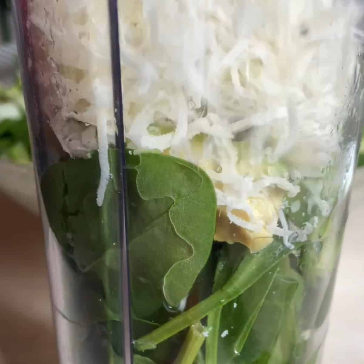 In a blender add the walnuts, vinegar, olive oil, spinach and avocado.