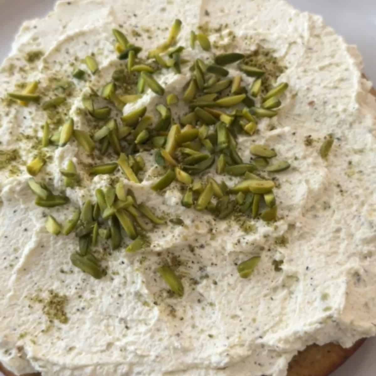 Top the cake with slivered pistachios.