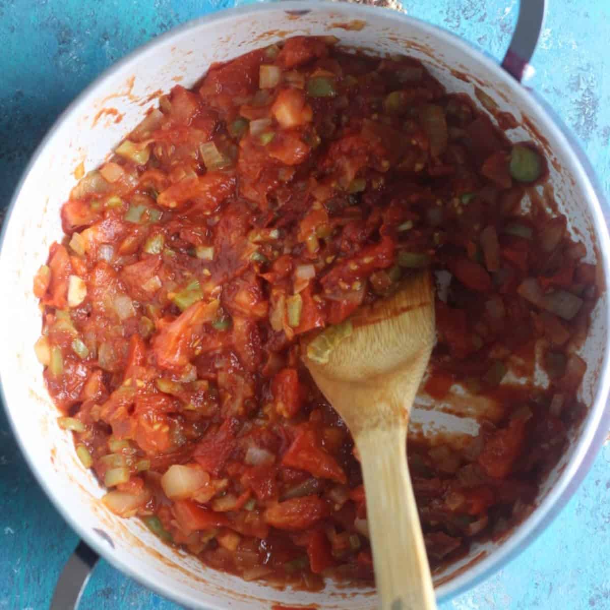 Add in the tomatoes, tomato paste and spices. 