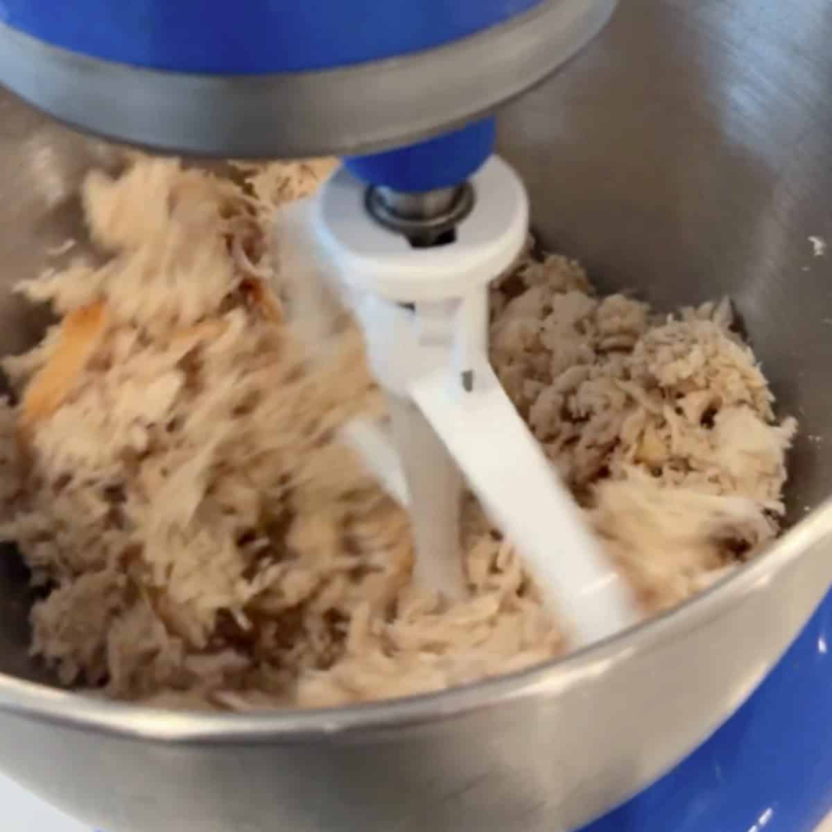 Shred the chicken in a stand mixer.