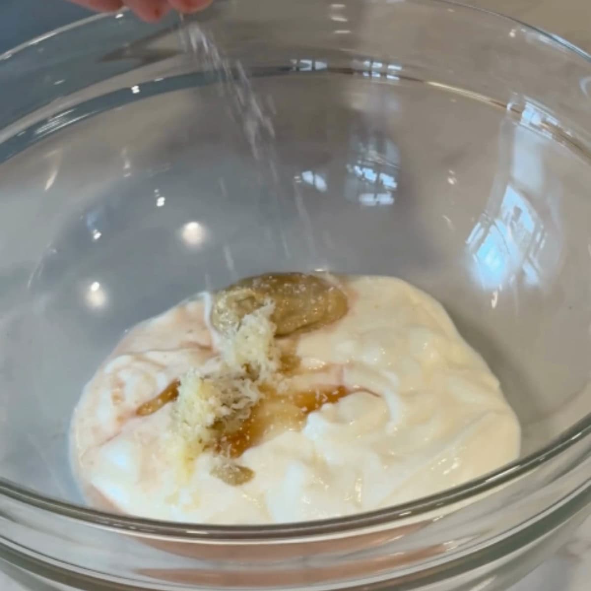 To a large bowl add the yogurt, vinegar and spices