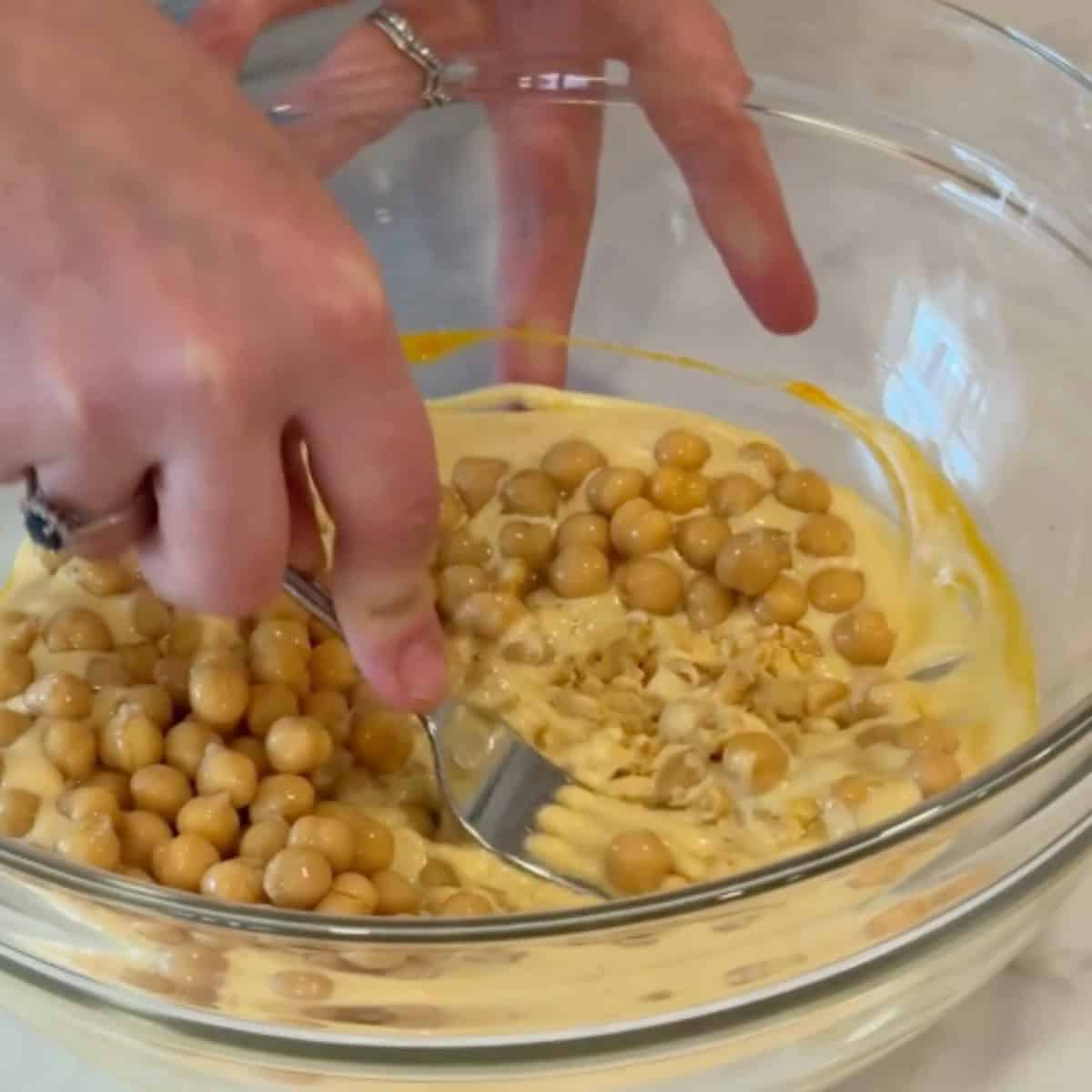 Add the chickpeas and mash them.