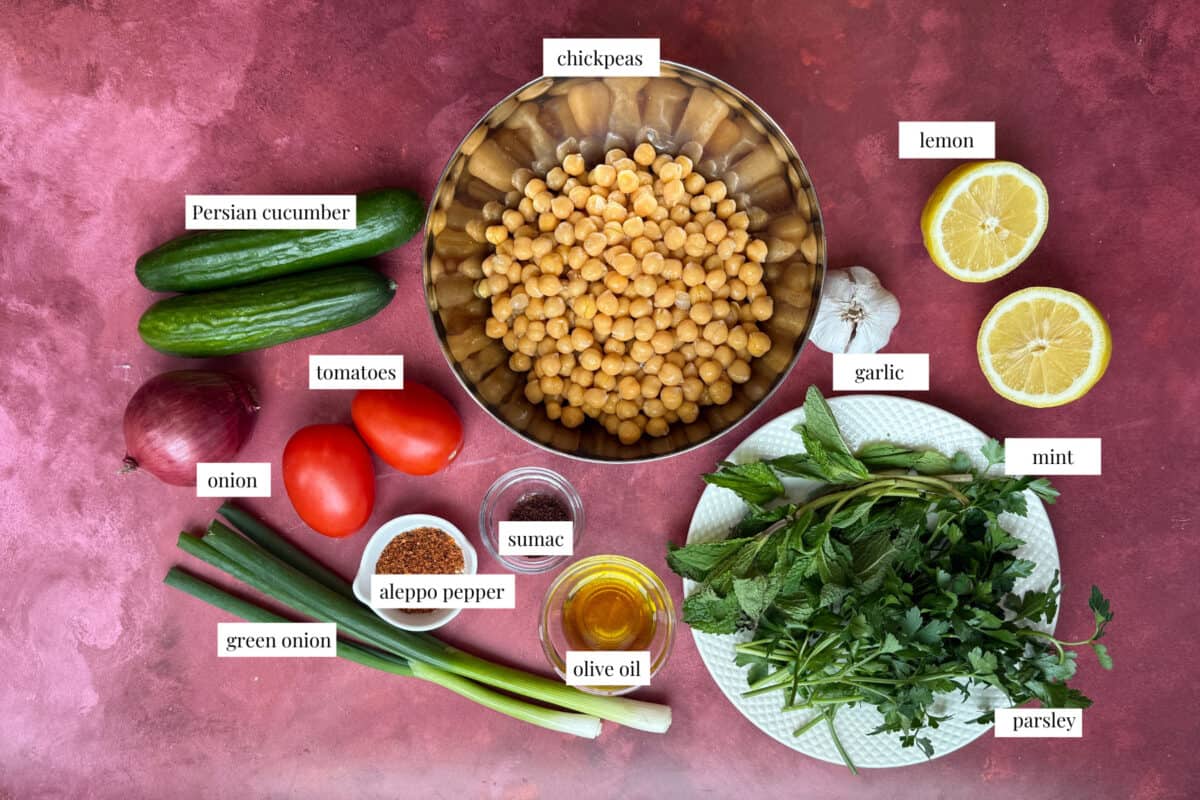 balela salad ingredients are chickpeas cucumbers red onion tomatoes herbs olive oil lemon and sumac