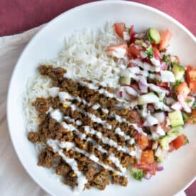 Ground beef bowl with rice and salad.
